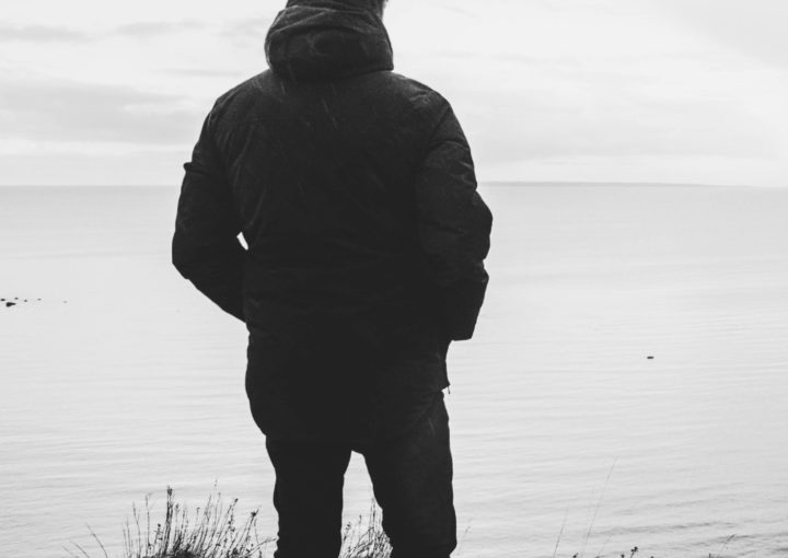 An image of a person looking out across an expanse of water