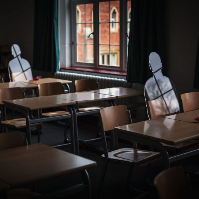 Silhouettes in Radley College. sitting at wooden desks