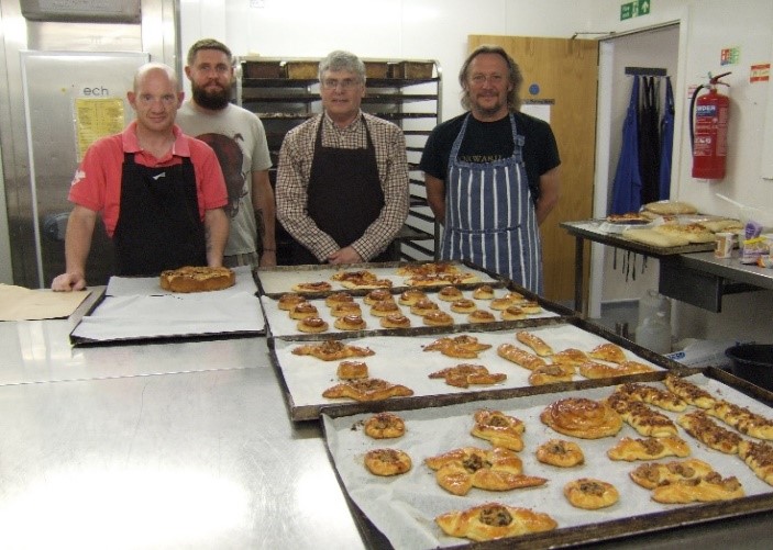 People baking food at the Church Homeless Trust,