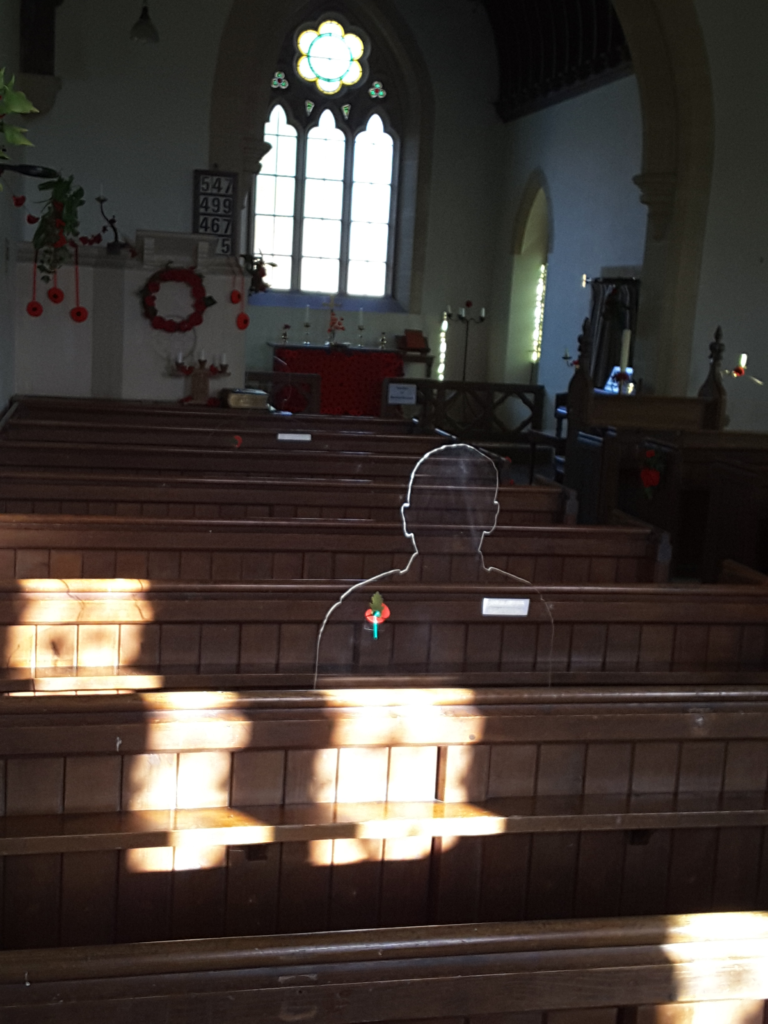 A silhouette in a church. The silhouette is in shadow i