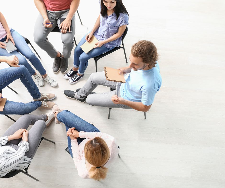 partners sitting in a circle in conversation.
