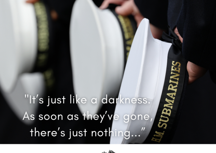 A line of submariners. Hands behind their back holding their hats