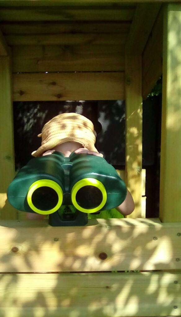 A military pre-school child with binoculars