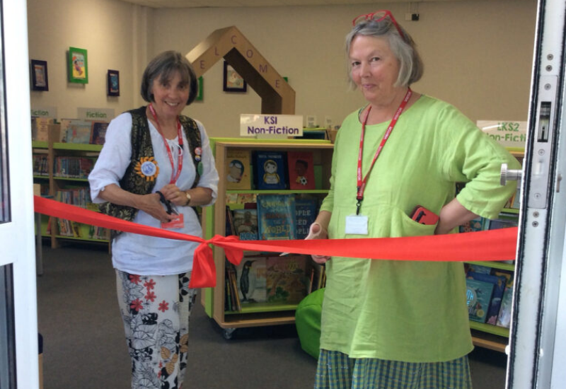 Staff cutting a red ribbon at Larkhill Primary School library