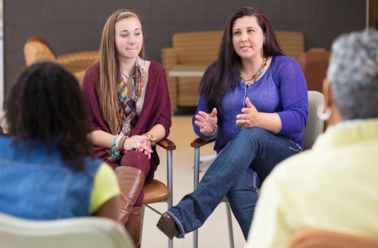 Representative visual showing participants at a meeting.